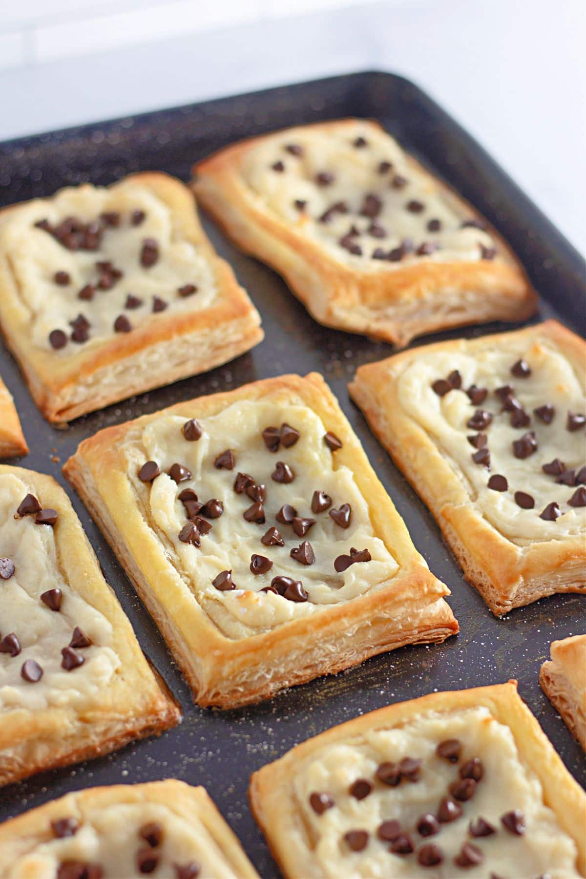 chocolate chip danishes cooling on a baking sheet.