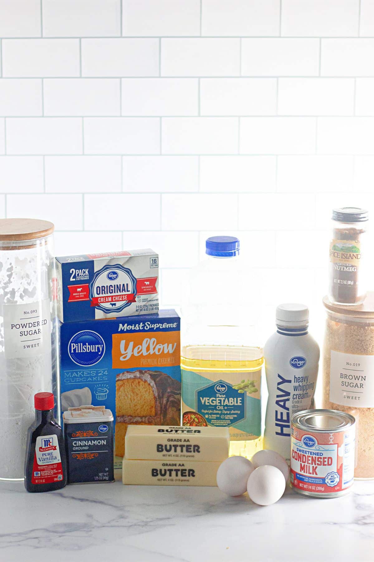 ingredients needed to make a cinnamon roll poke cake on a counter.