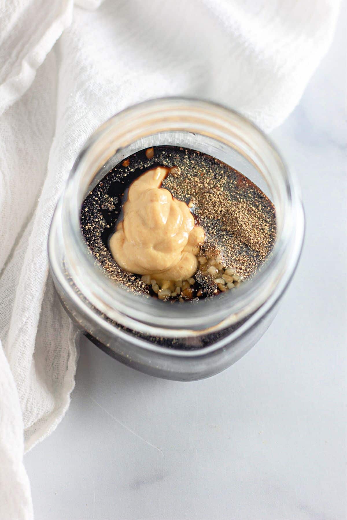 balsamic dressing being mixed in a small mason jar.