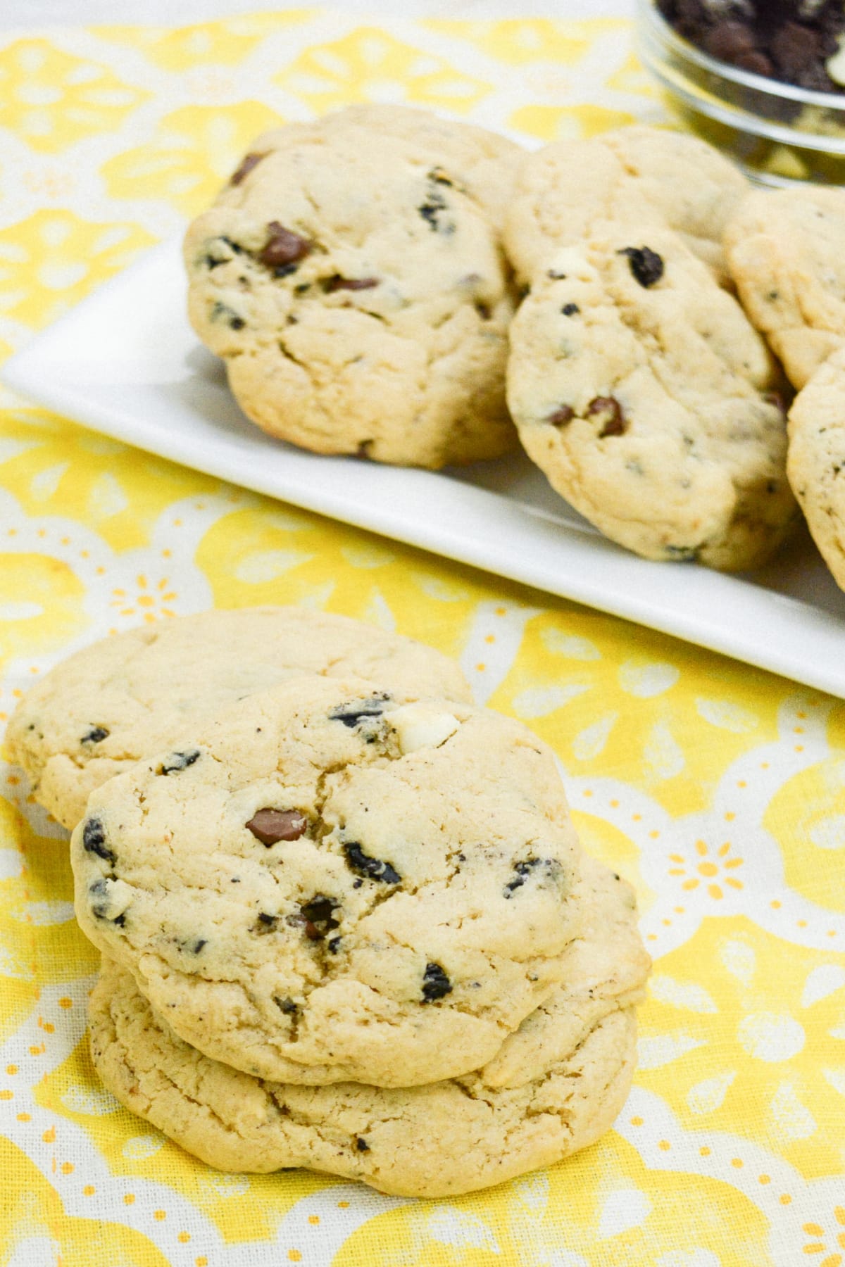 three cookies and cream cookies stacked on a table.