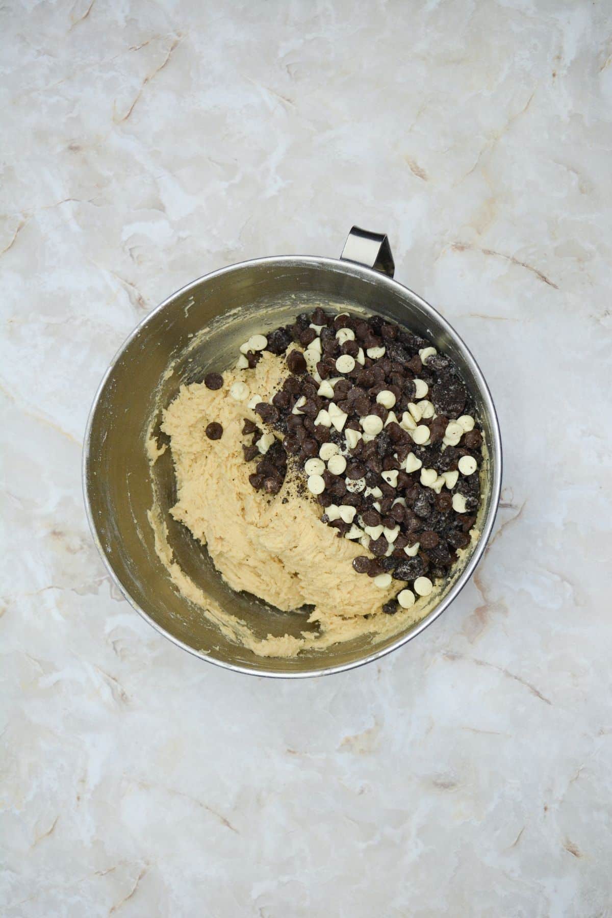 chocolate chips being added to cookie dough.