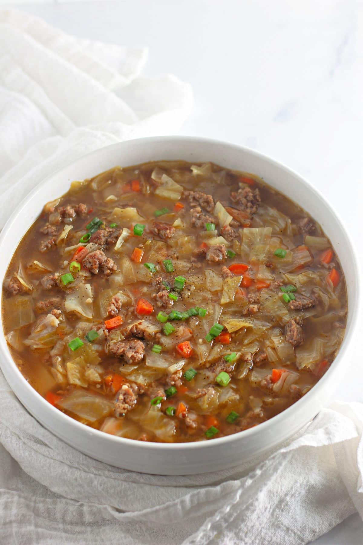 bowl full of eggroll soup on a table.