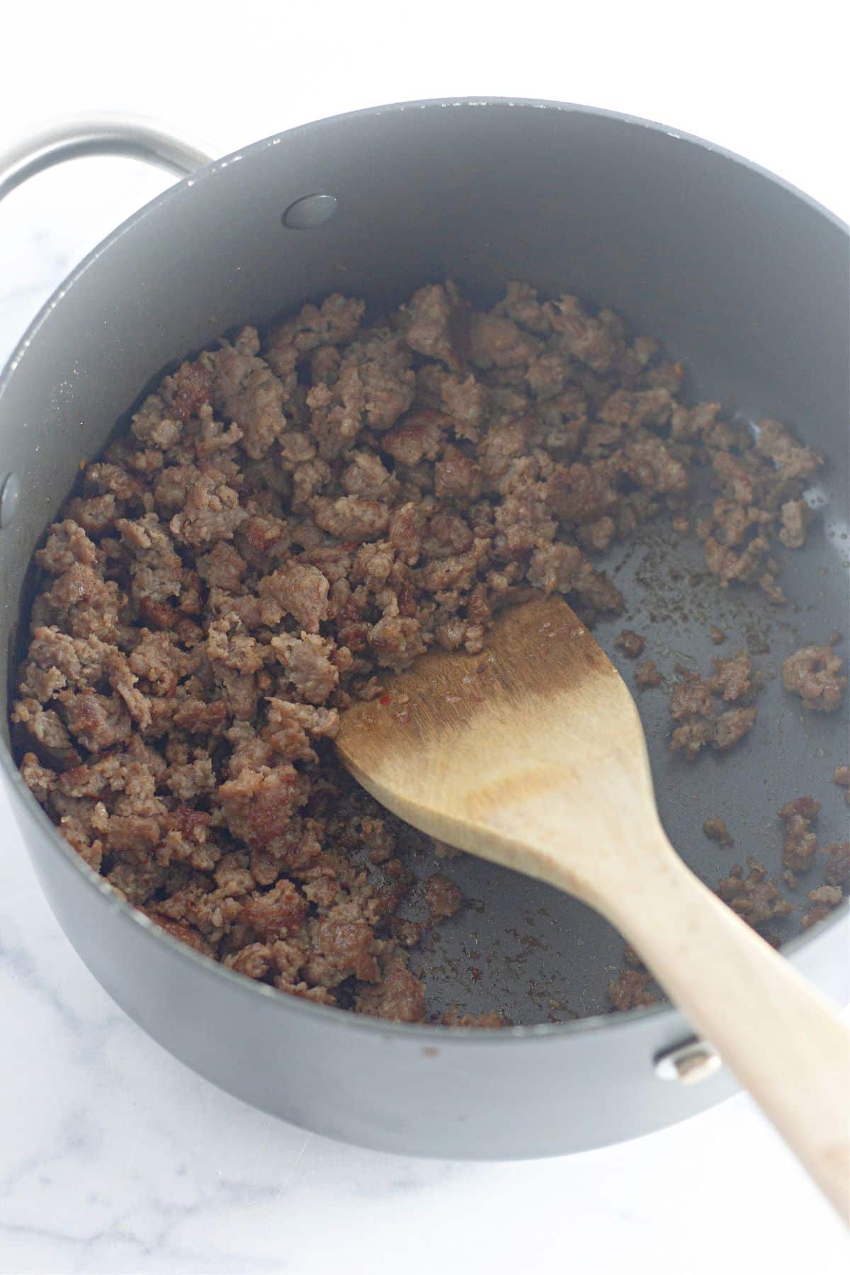 ground pork being browned in a large pot.