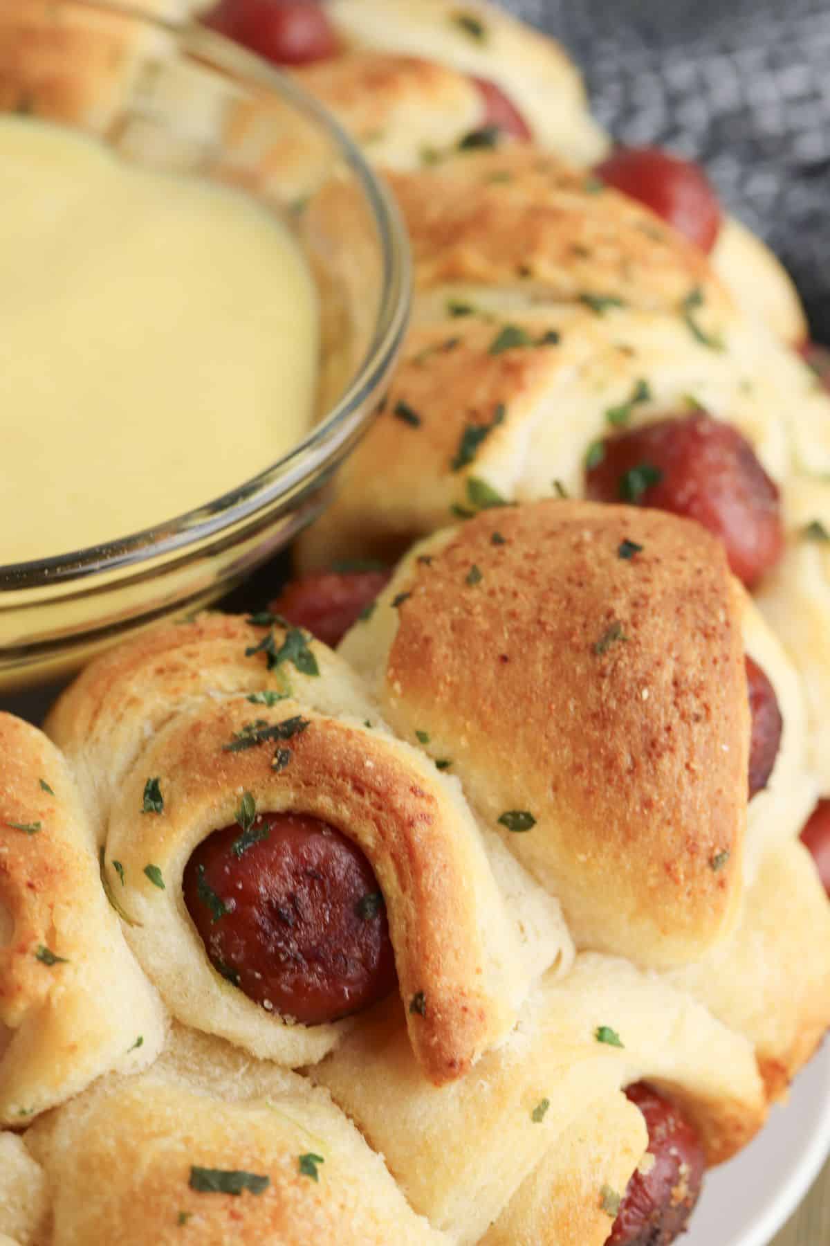pigs in a blanket pull apart on a plate.