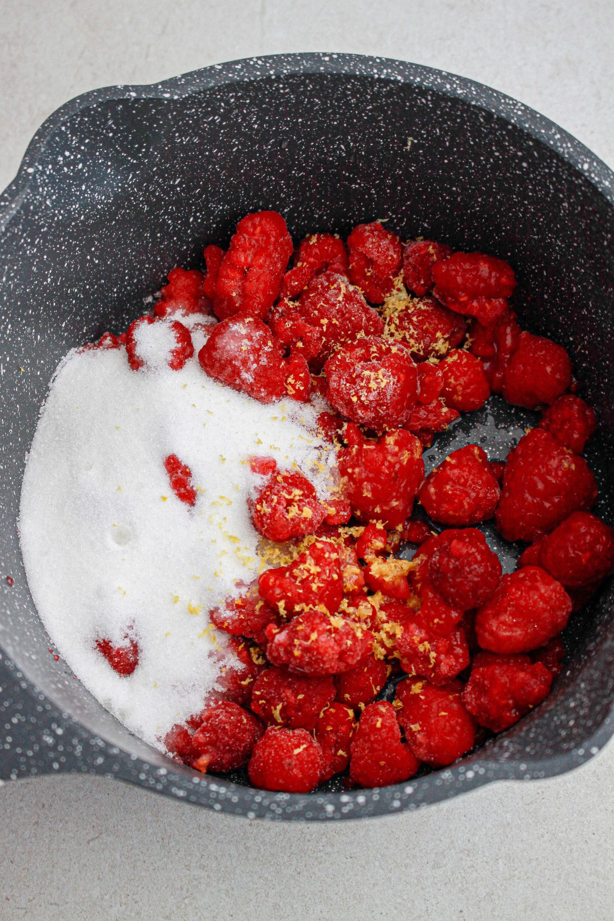 raspberries, lemon zest, and sugar, in a large pot.
