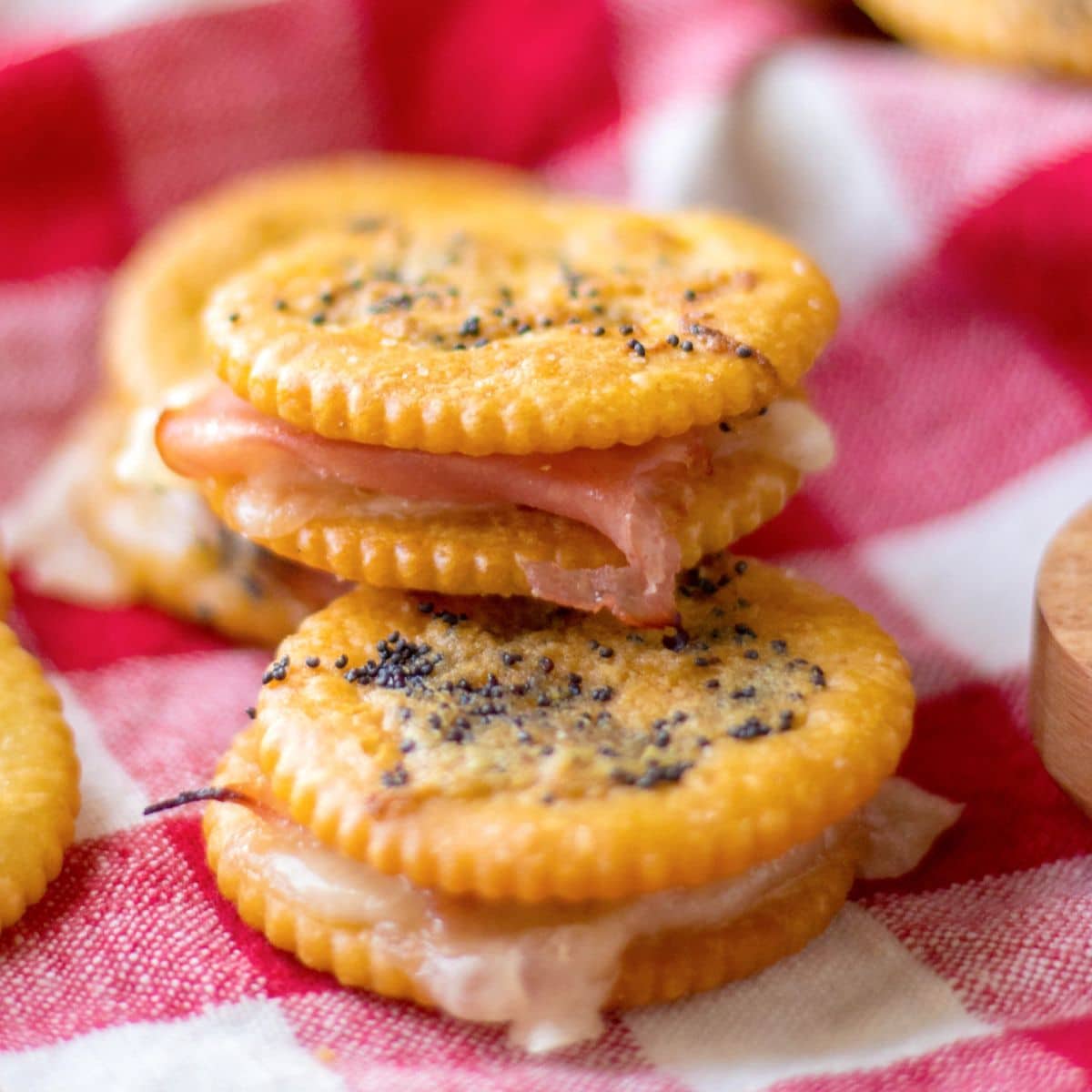 three ritz ham and cheese sandwiches stacked in a pyramid.