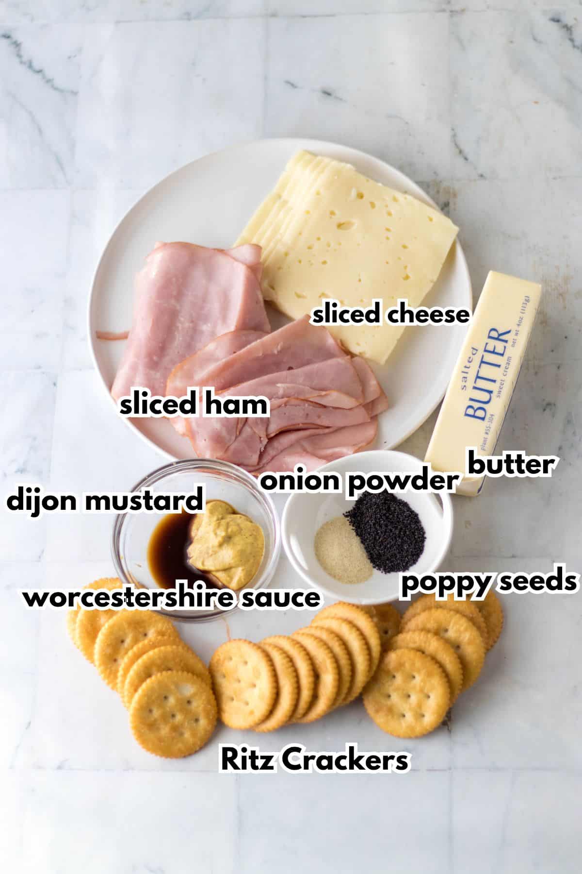 sliced ham, sliced cheese, dijon mustard, onion powder, butter, worcestershire sauce, poppy seeds and Ritz crackers.