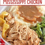 slow cooker Mississippi chicken on a plate with green beans and mashed potatoes.
