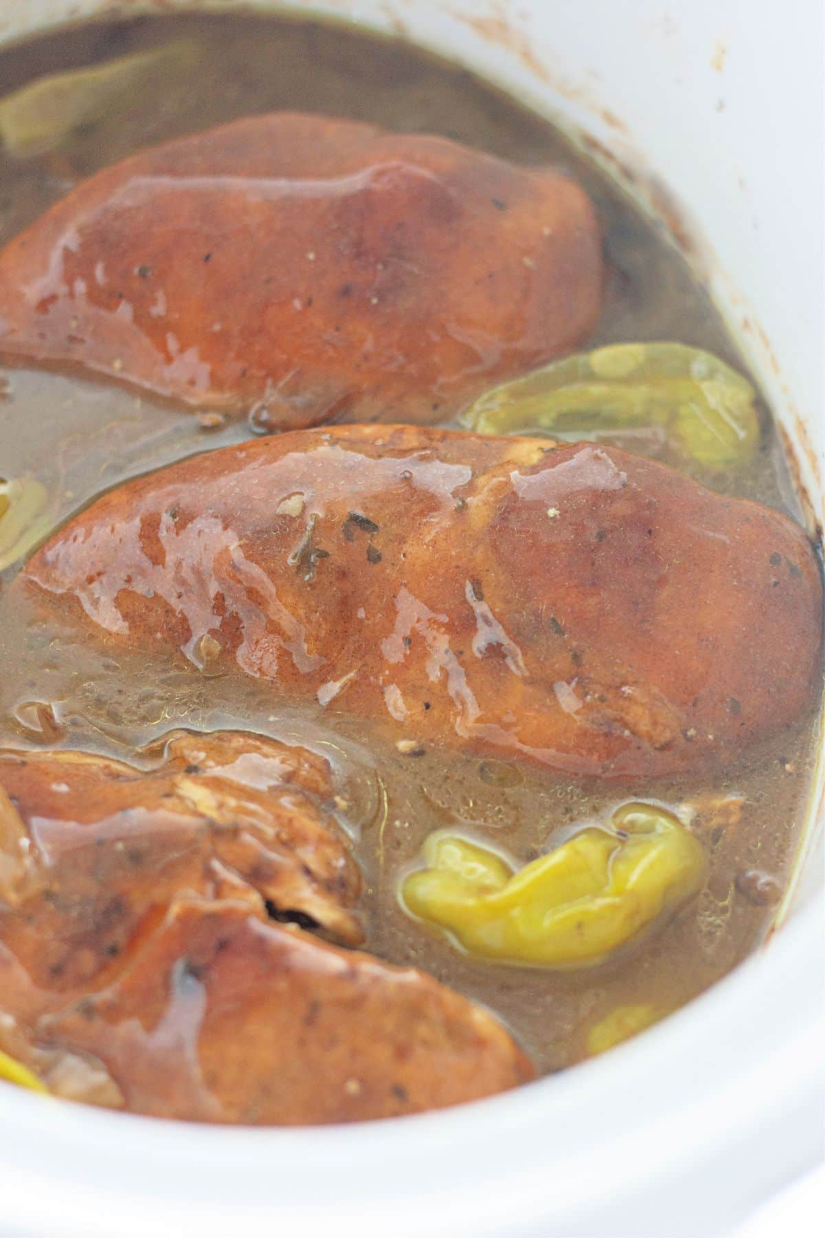 cooked chicken and peppers in a slow cooker.