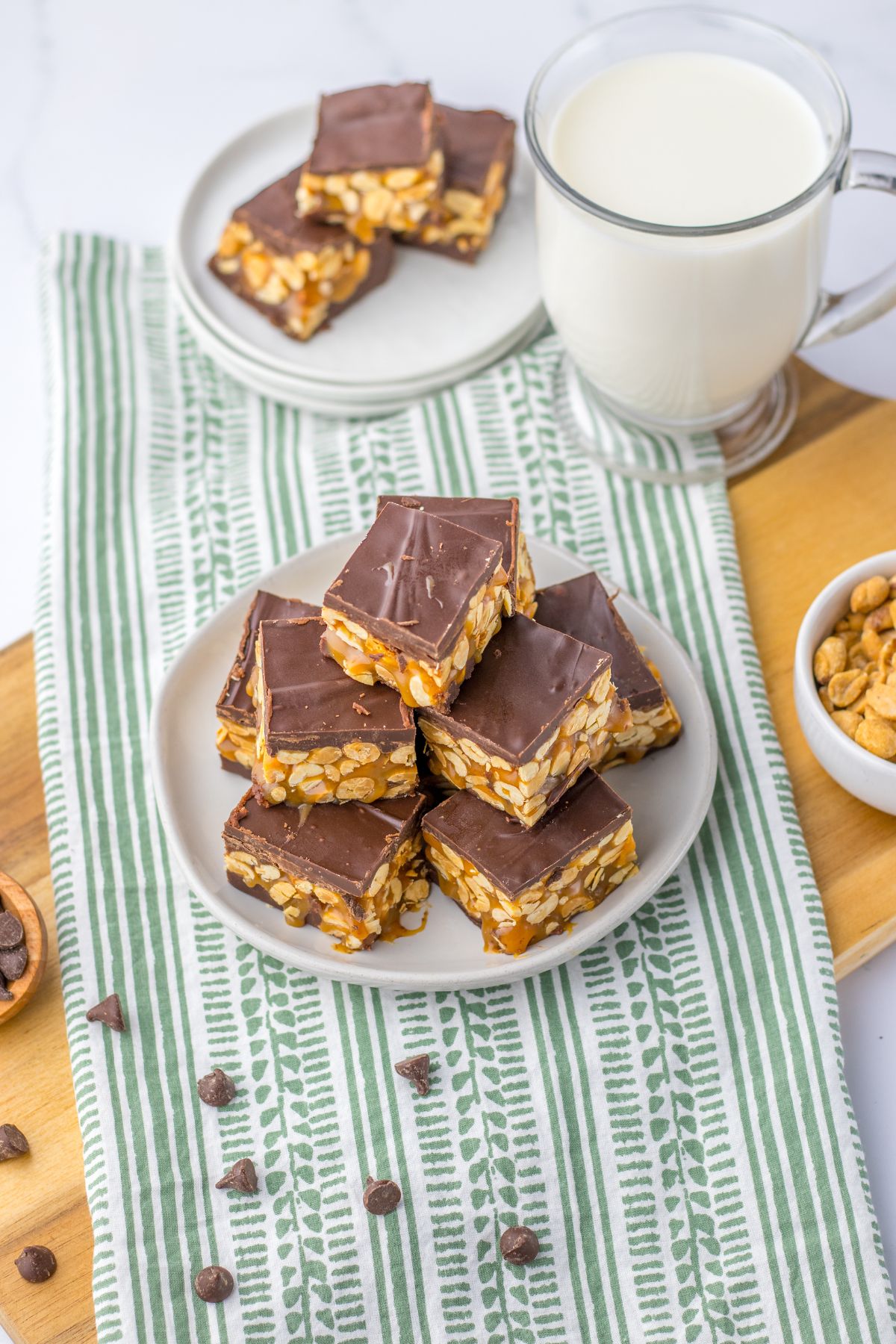 pieces of snickers fudge stacked in a pyramid on a plate.