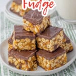 pieces of snickers fudge stacked in a pyramid on a plate.