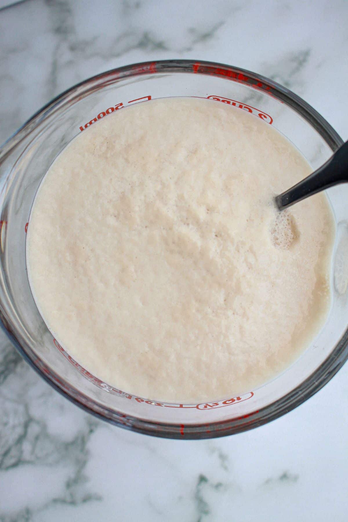 yeast blooming in a glass mixing bowl.