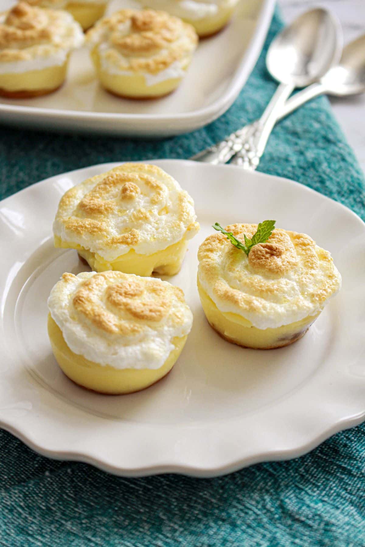 three banana pudding cups on a plate.