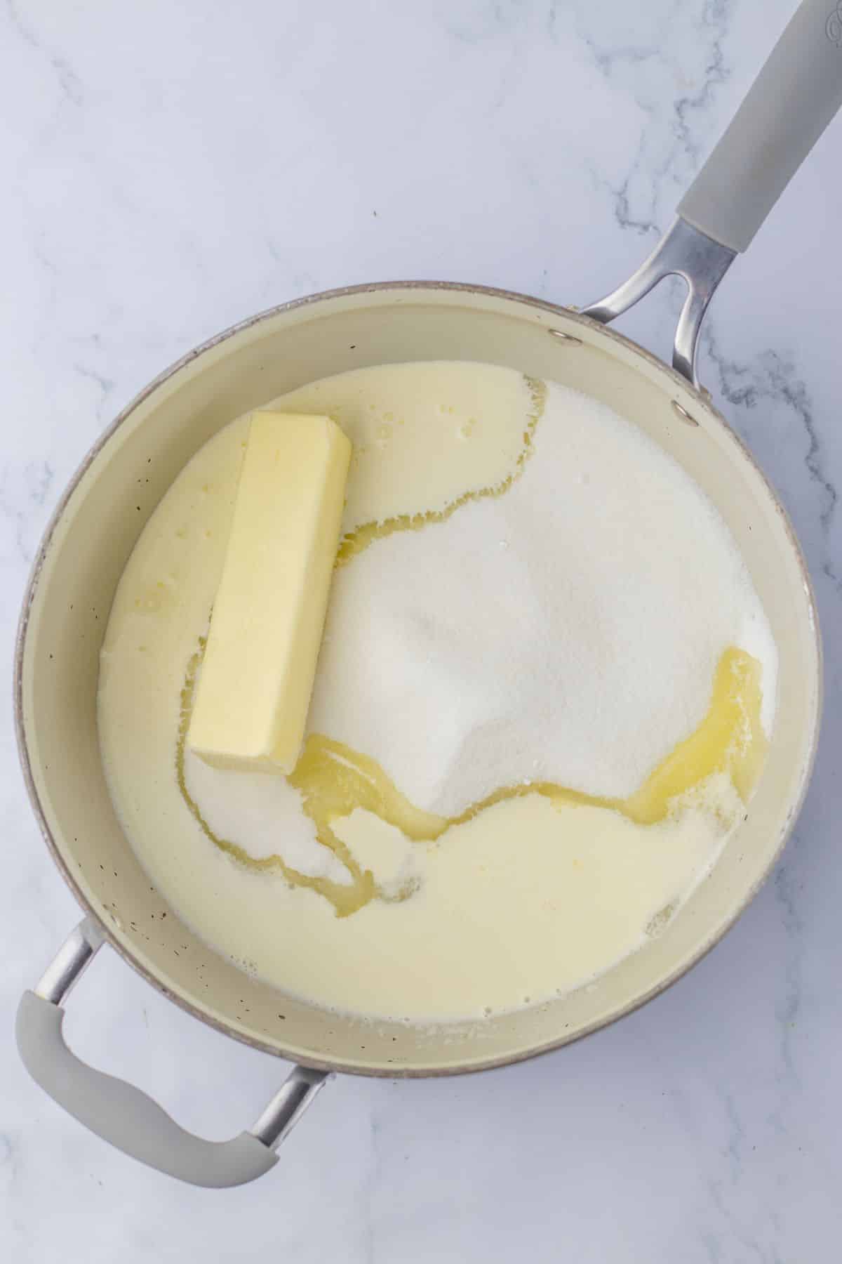 butter and sugar being mixed in a saucepan.