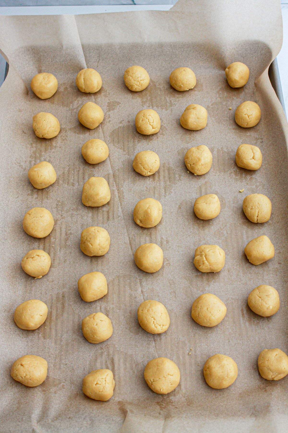 truffles shaped and laid out on a parchment lined baking sheet.