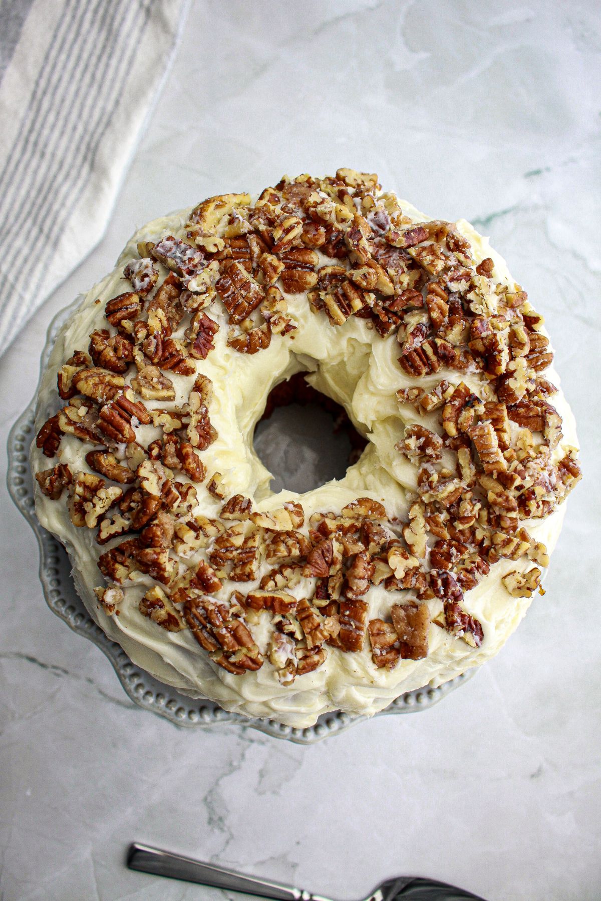 uncut butter pecan pound cake on a plate.