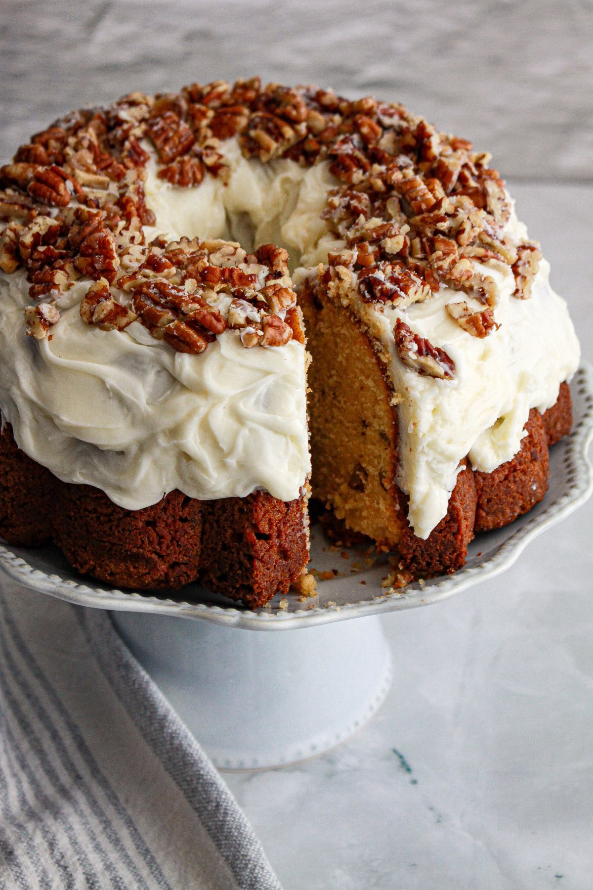 cake on cake plate with a slice missing.