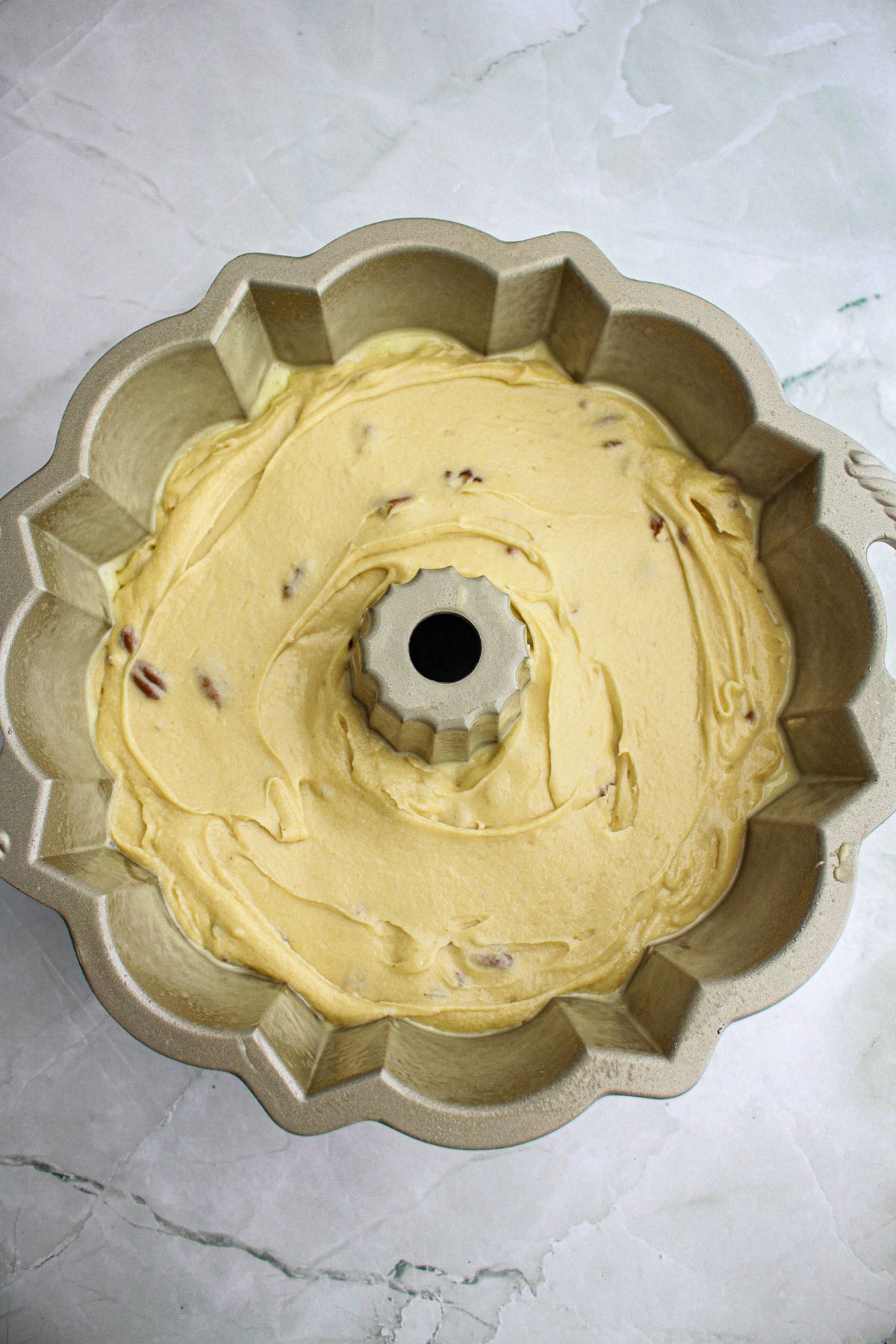 cake batter in a bundt cake pan.