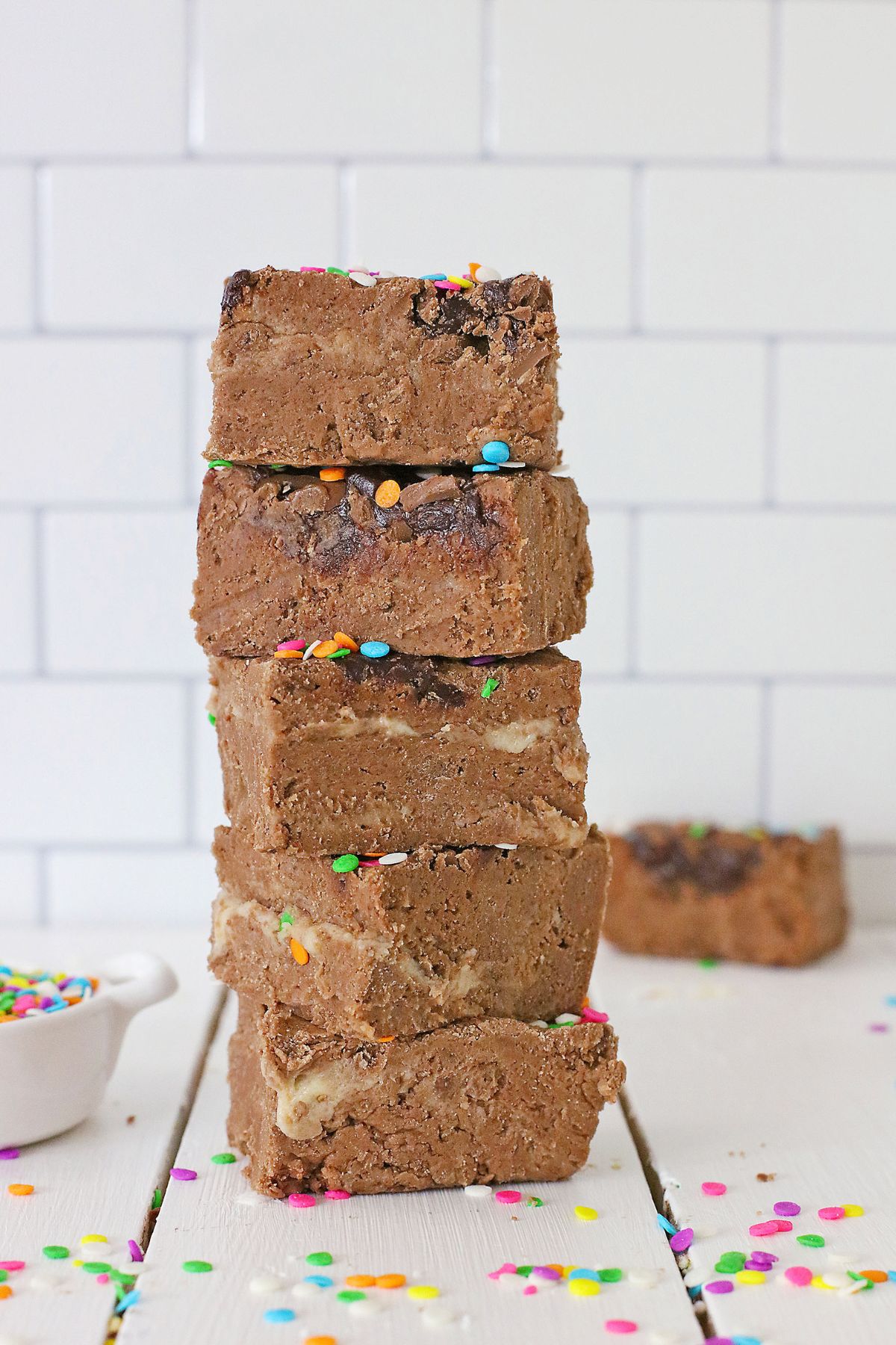 five places of cadbury fudge stacked on top of each other on a counter.