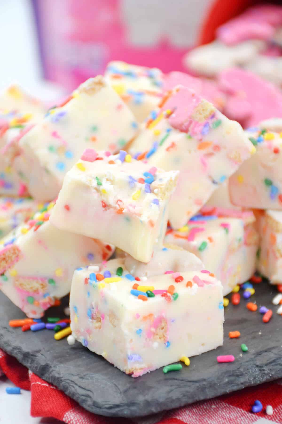 pieces of circus animal cookie fudge stacked on a piece of marble.