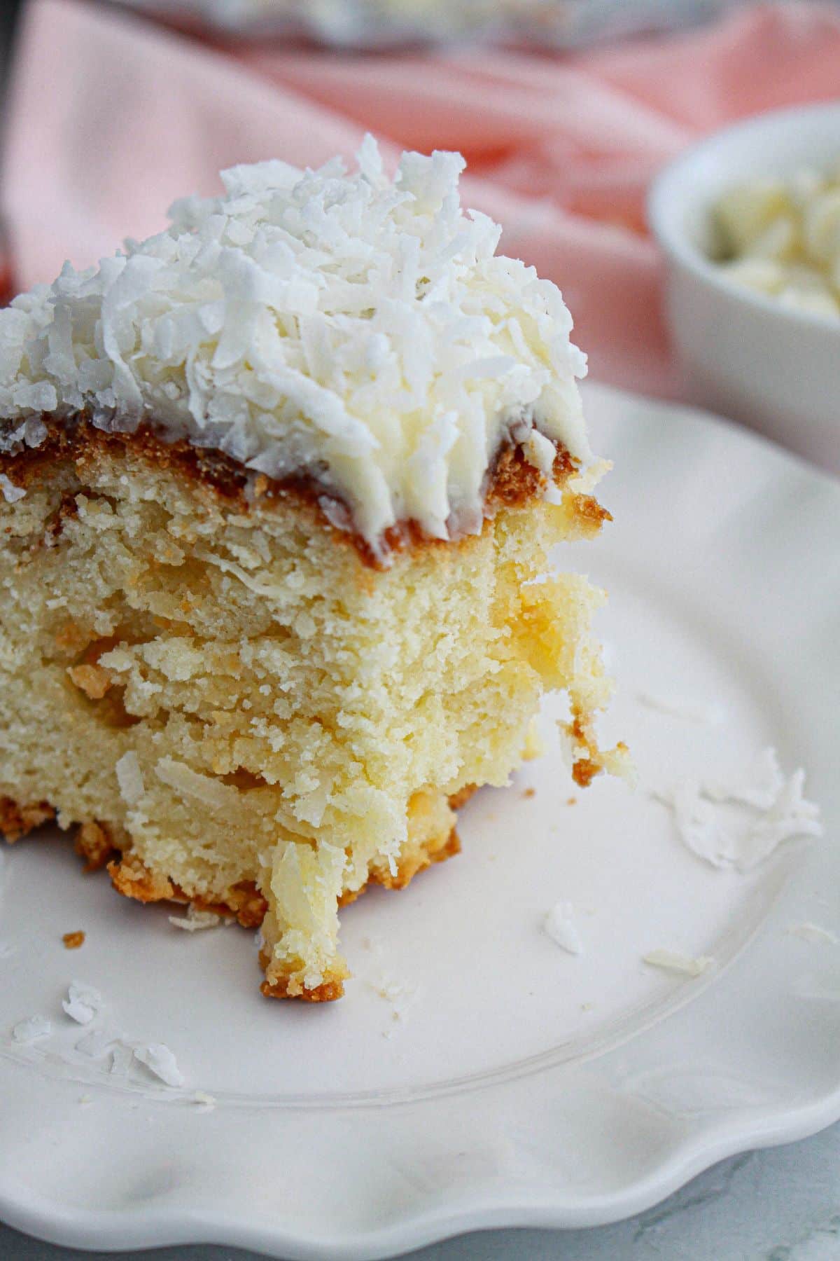 slice of coconut white chocolate cake on a plate.