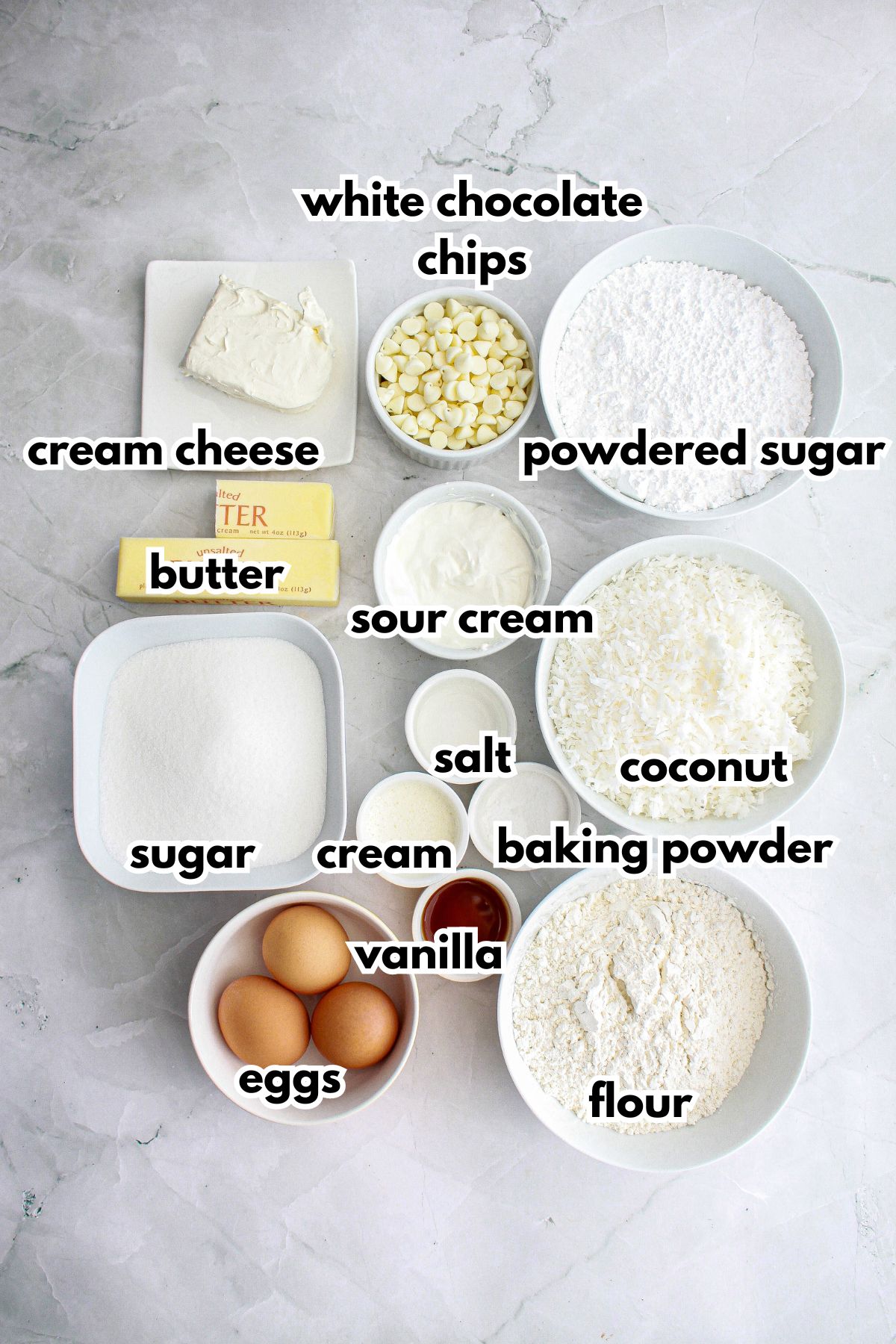 bowls of cream cheese, white chocolate chips, powdered sugar, butter, sour cream, sugar, salt, cream, baking powder, coconut, eggs, vanilla, and flour