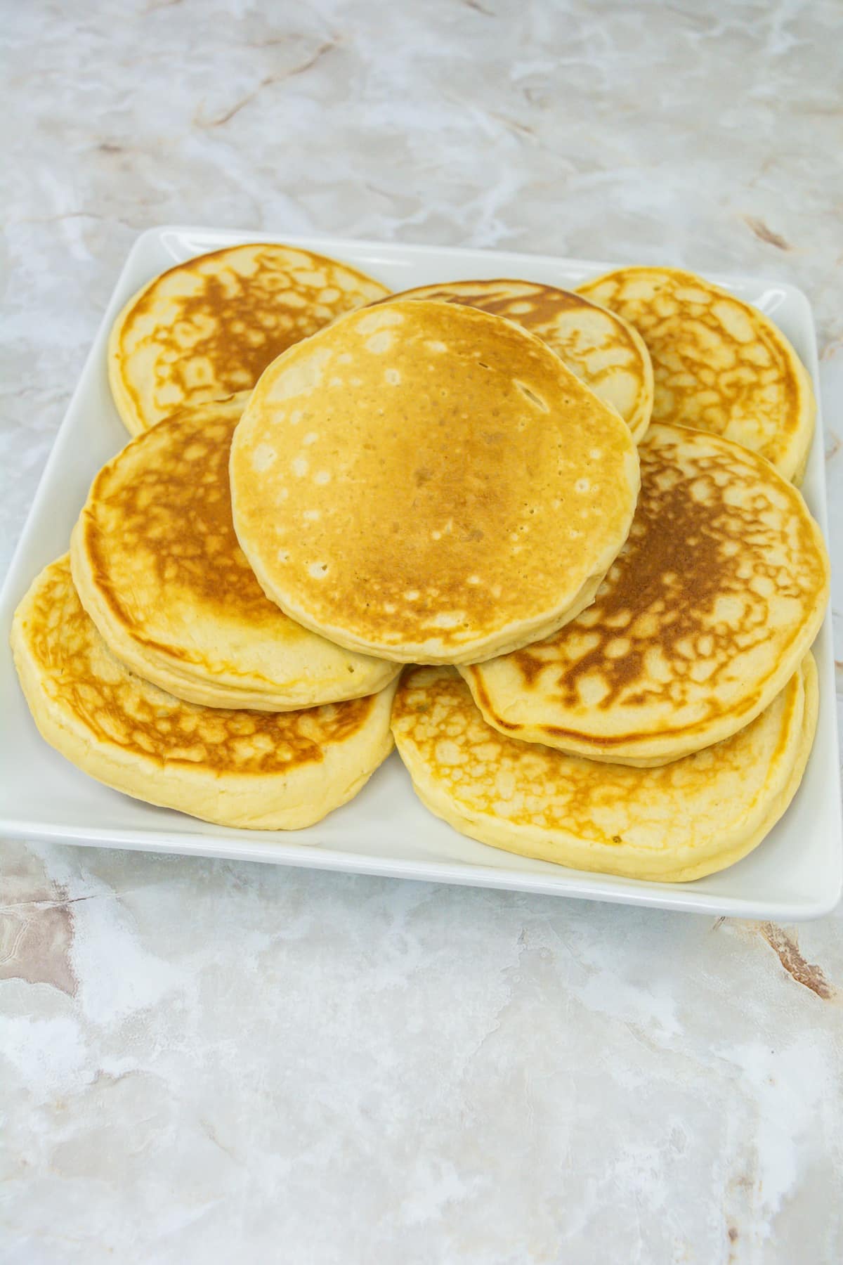 homemade pancakes stacked on a plate.