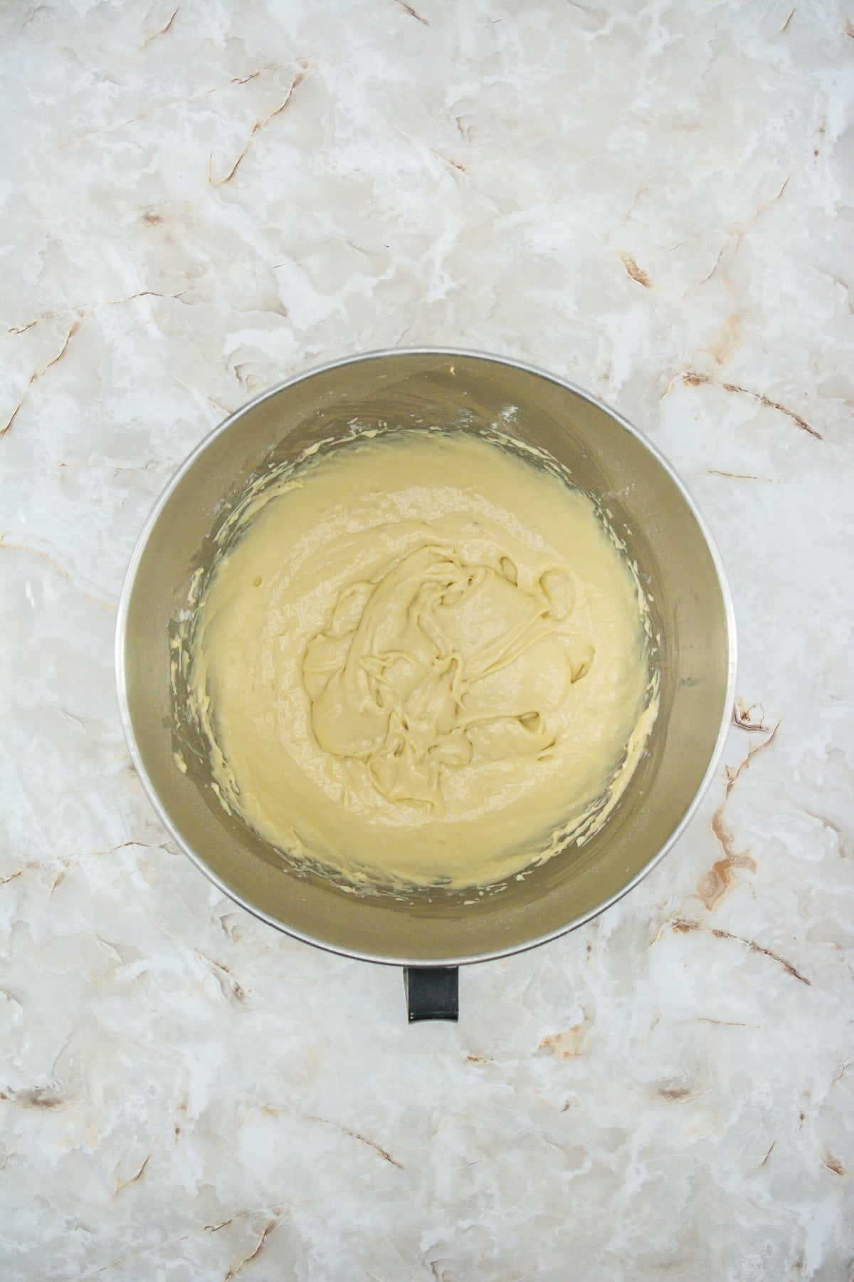 pancake batter in a stainless steel mixing bowl.