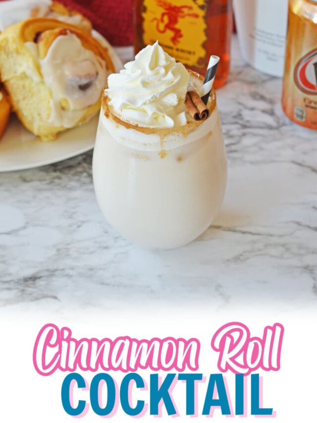 cinnamon roll cocktail on a marble counter topped with whipped cream and a cinnamon stick.