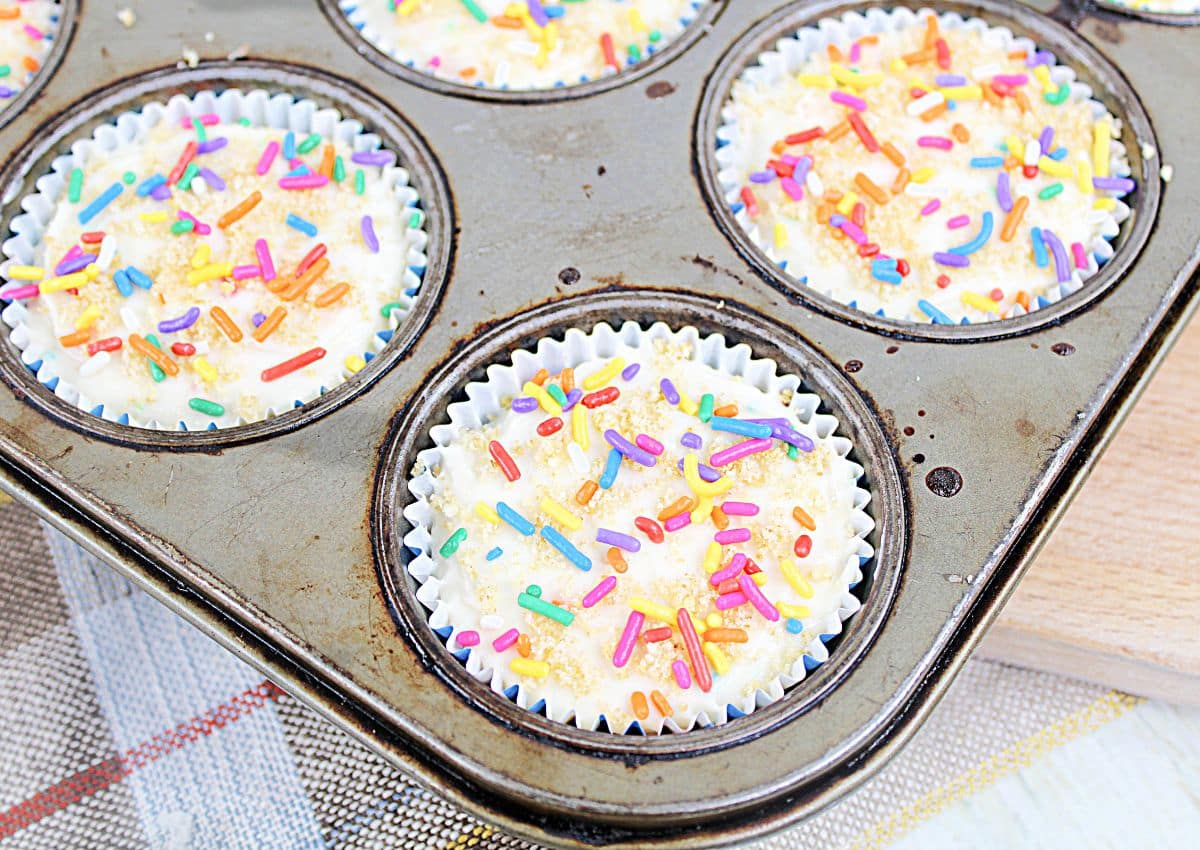 mini dunkaroo cheesecakes cooling in a muffin pan.