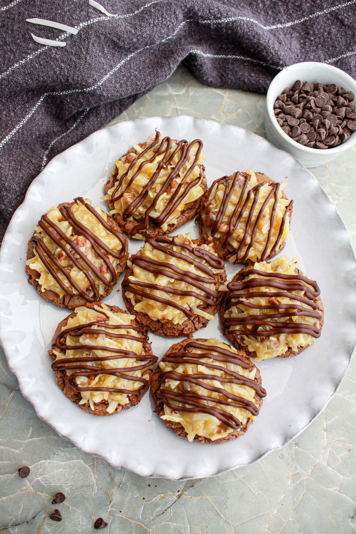seven german chocolate cake cookies on a plate.