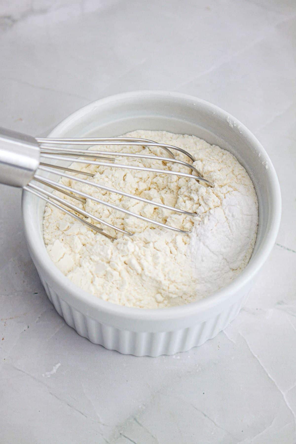 dry ingredients being whisked in a small bowl.