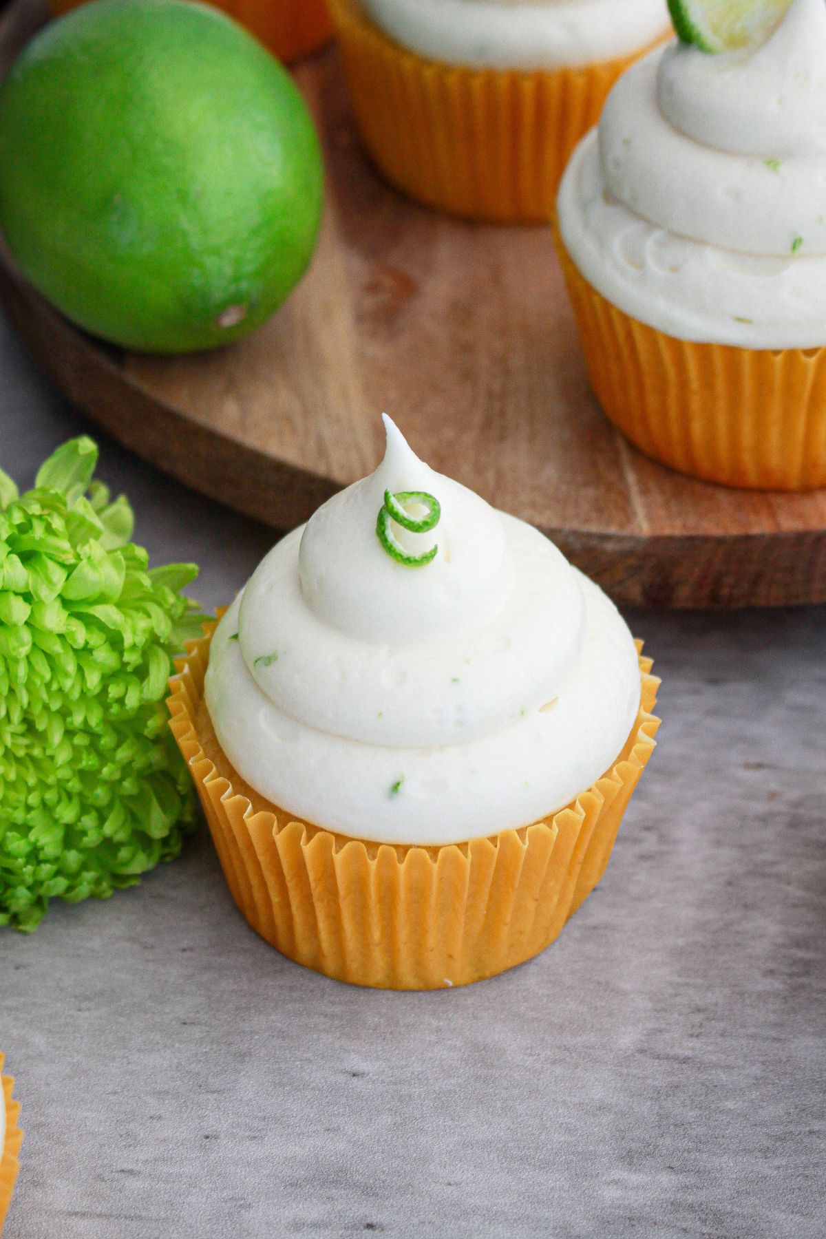 frosting being added on top of cupcakes.
