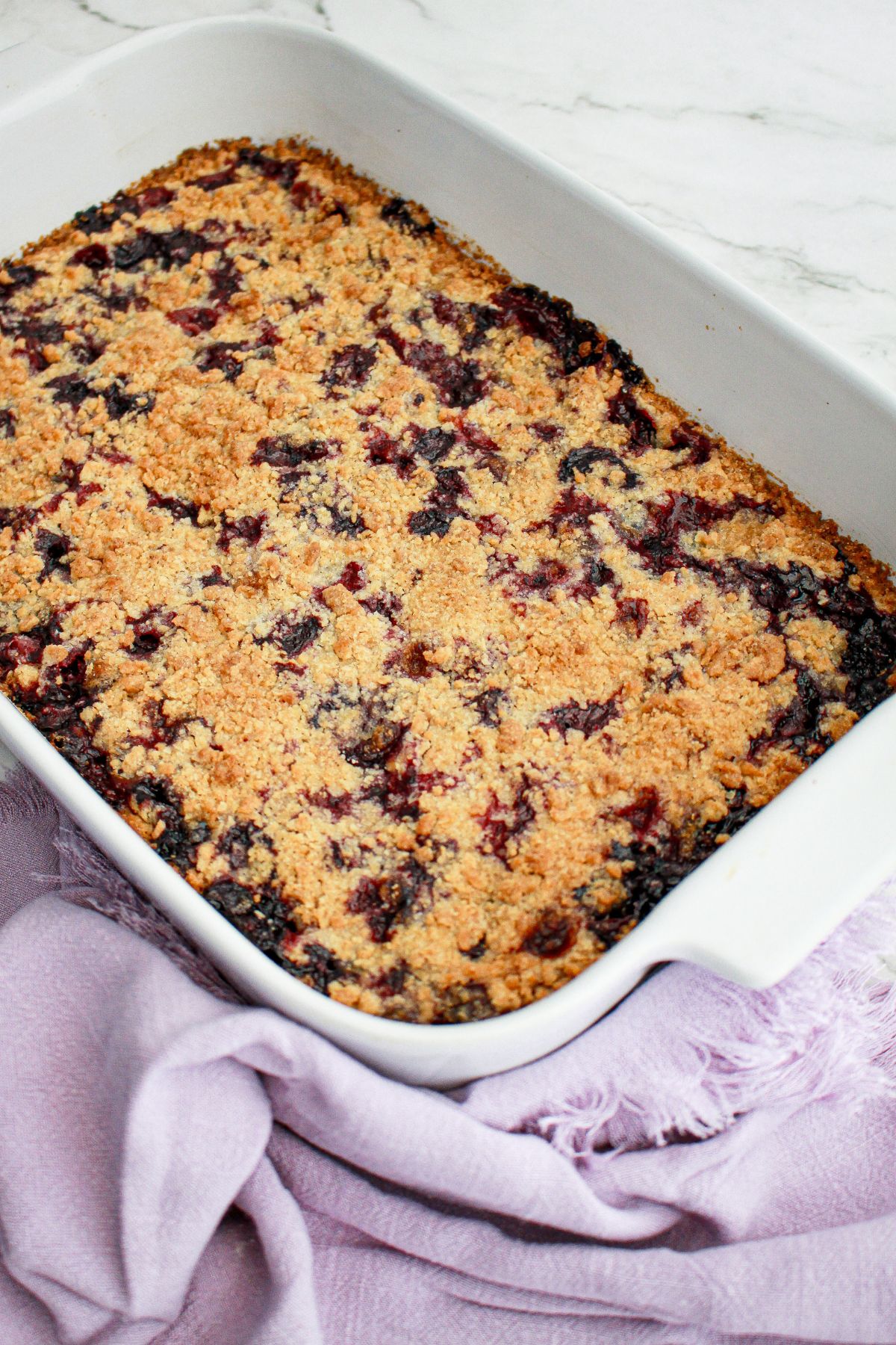 baked lemon raspberry crumb bars in a casserole dish.