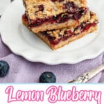 two lemon raspberry crumb bars stacked on a a plate.