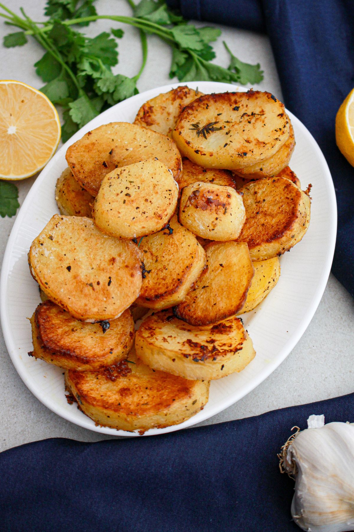 melting potatoes stacked on a plate.