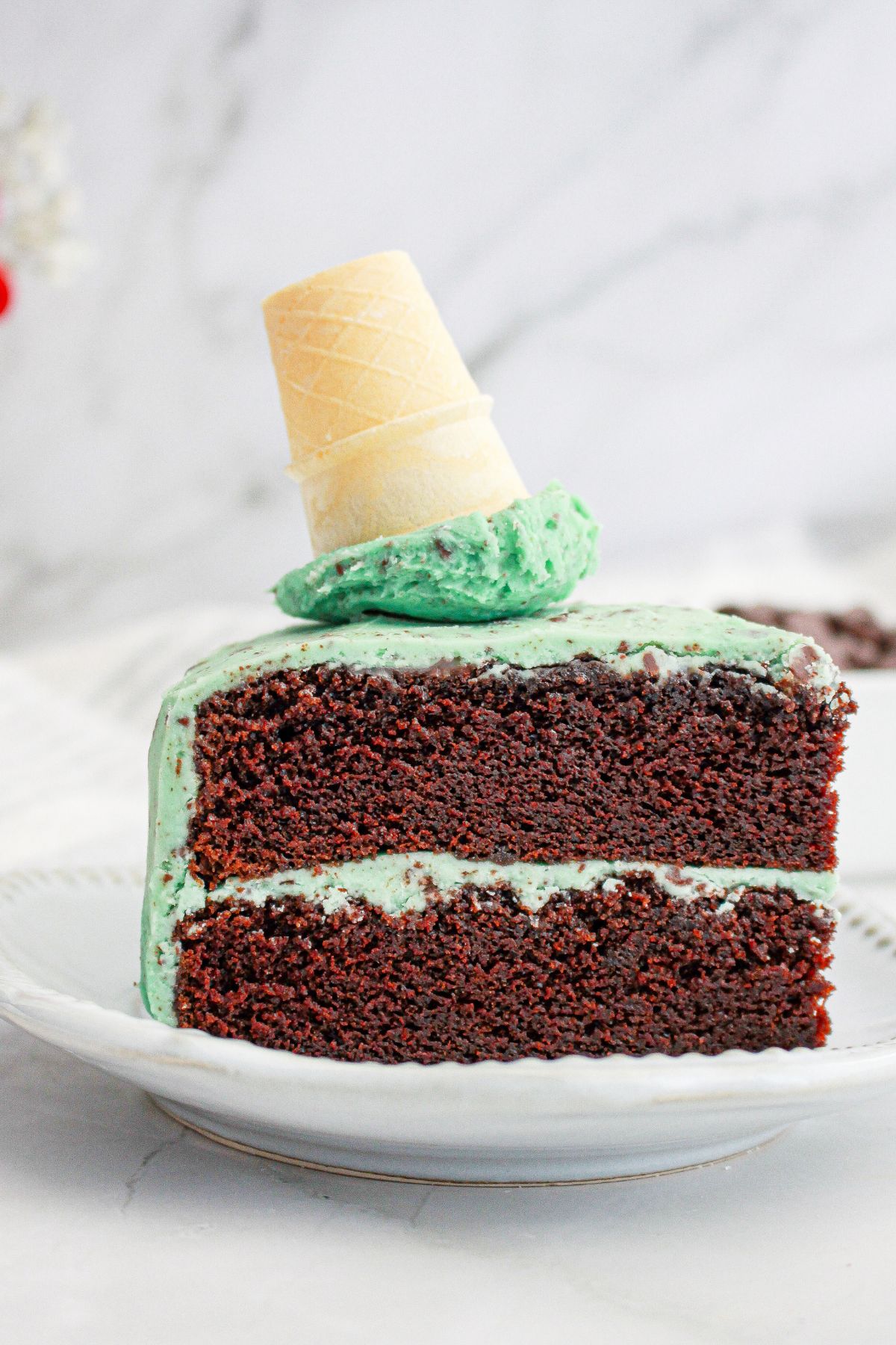 Slice of mint chocolate chip cake on a small plate.