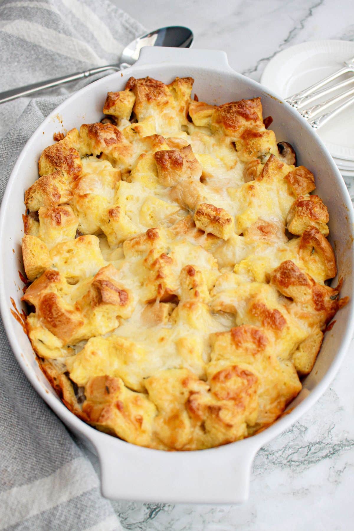 uncut mushroom bread pudding in a casserole dish.
