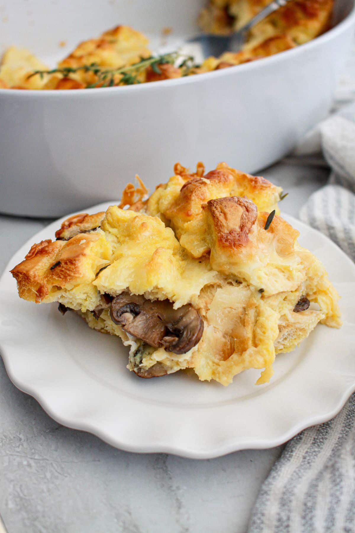 slice of mushroom bread pudding on a plate.