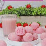 eight pink truffles stacked on a small white plate.