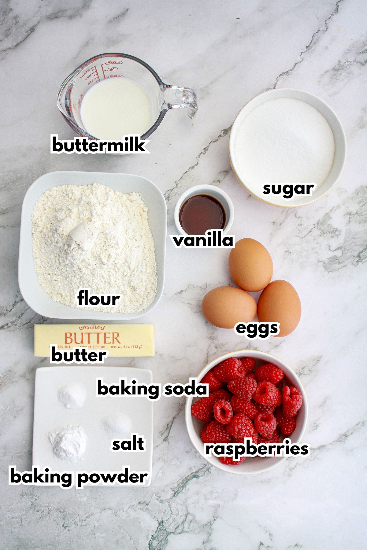 bowls of ingredients needed to make cupcakes on a counter.