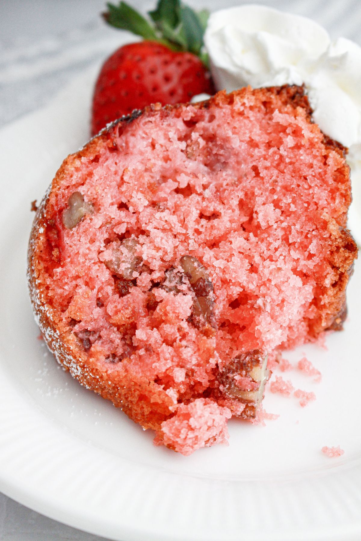 slice of strawberry cake mix bundt cake on a plate.