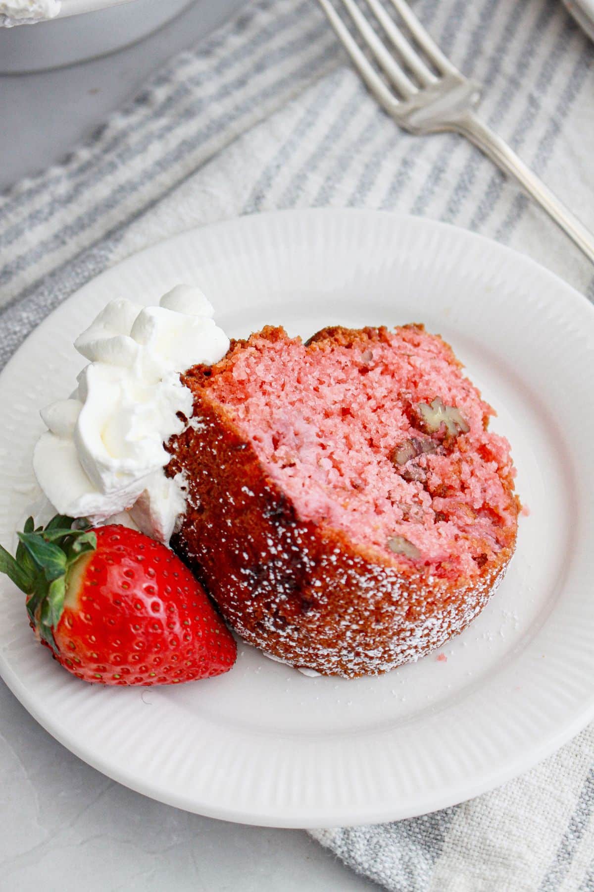 slice of strawberry cake mix bundt cake on a plate.
