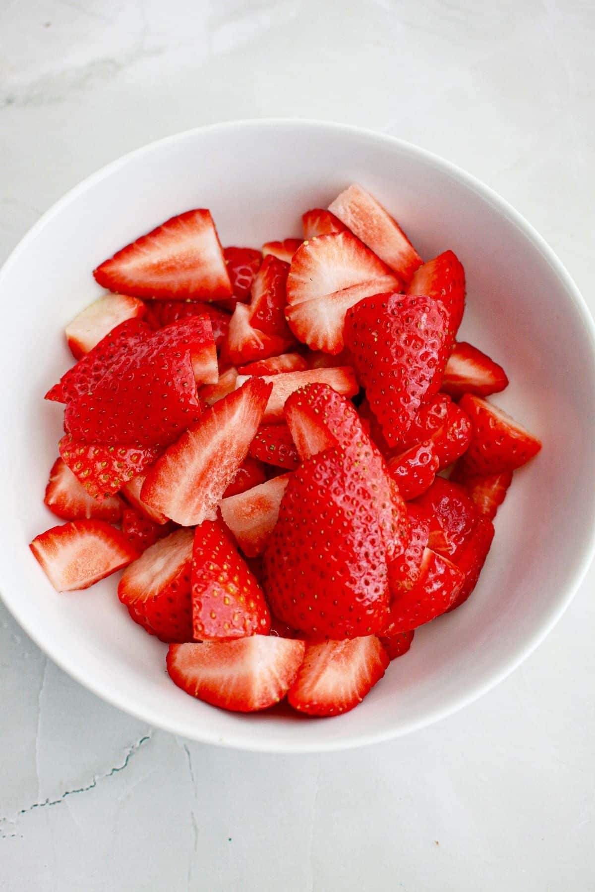 fresh sliced strawberries in a small bowl.