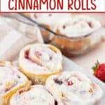 four strawberry cinnamon rolls on a plate.