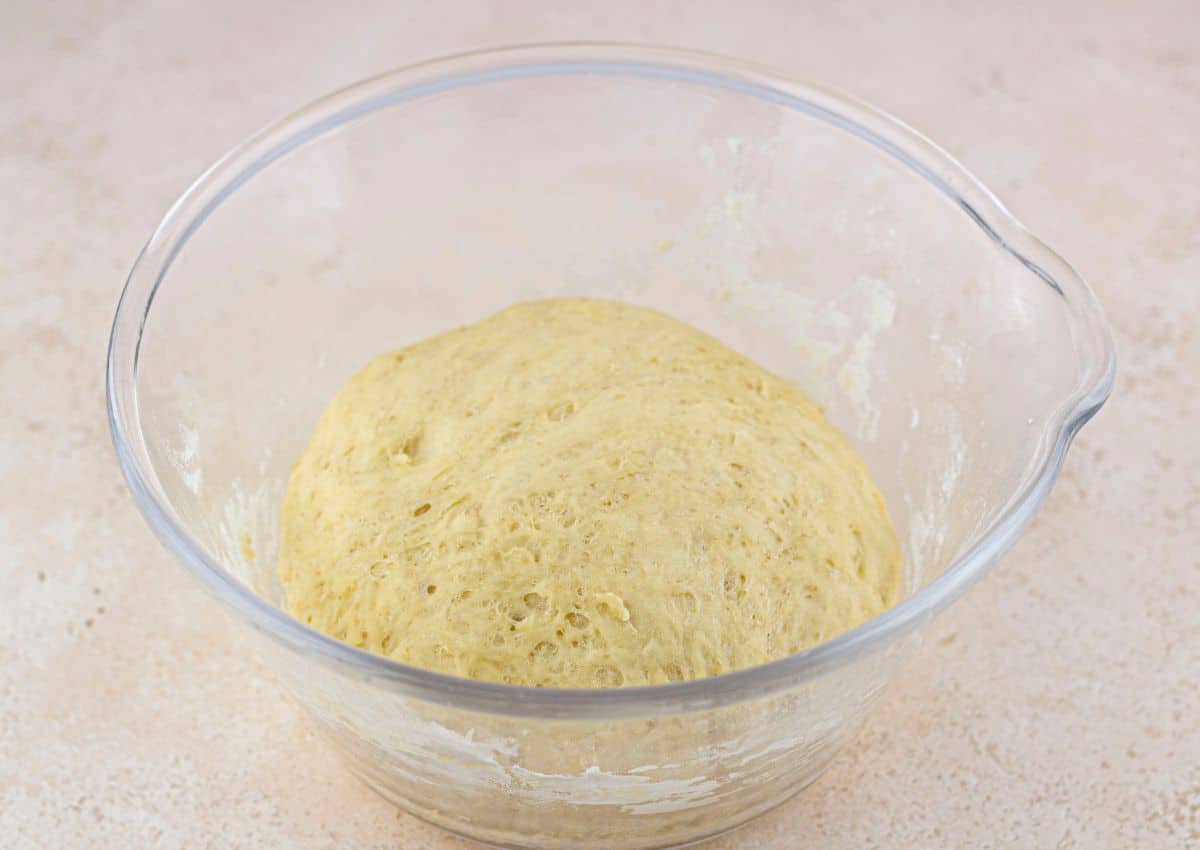 dough rising in a glass bowl.