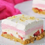 slice of no bake strawberry delight on a plate.