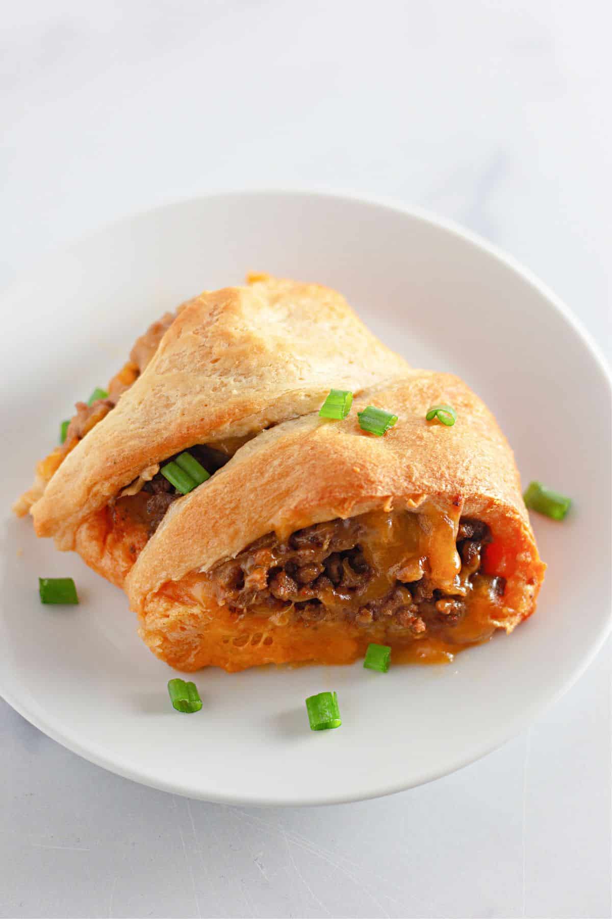 two slices of taco crescent ring on a plate.