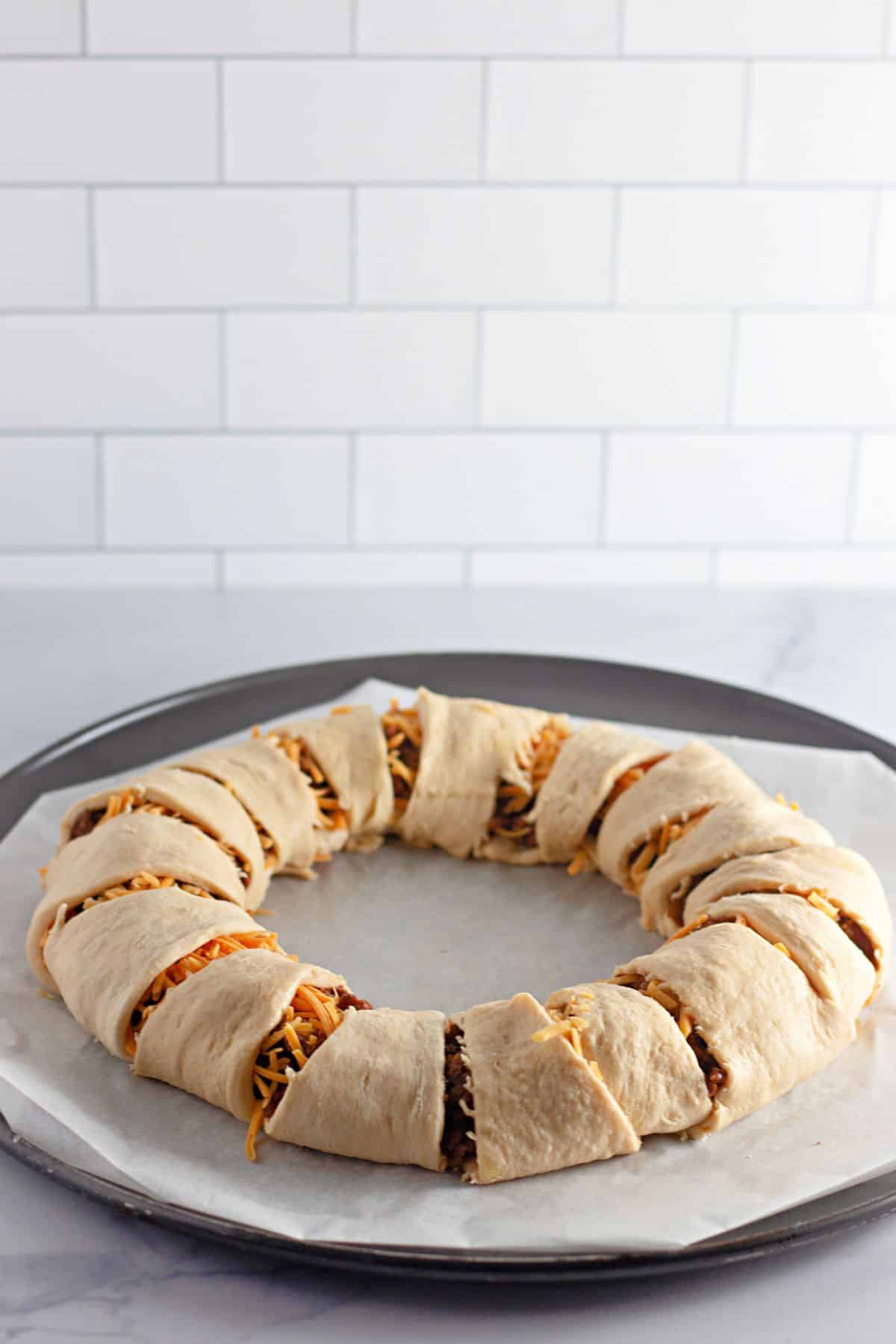 crescent rolls being wrapped around the crescent ring.