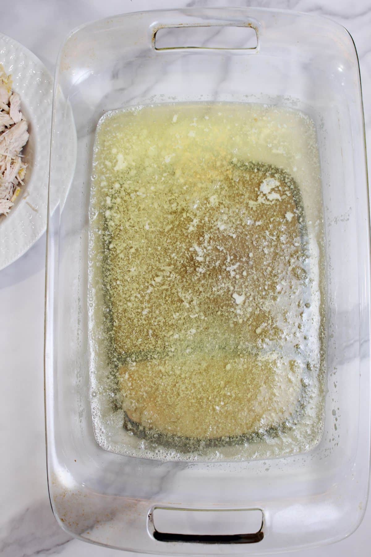 melted butter in a glass casserole dish.